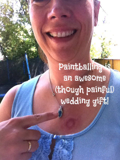 Paintballing is awesome (though painful) wedding gift. Poster of Carolyn Klassen pointing to deep circular bruise on herself from painting?